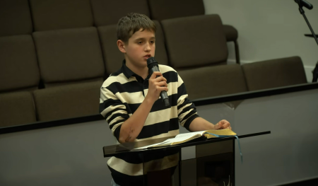 The late Matthew Stavkovy, 13, reads Scripture at Bread of Life Church in Kent, Washington.