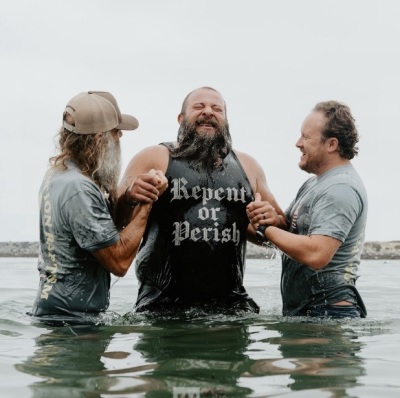 A man is baptized at the second annual Jesus Revolution Baptism at Pirate's Cove Beach in Corona Del Mar, California, on Saturday, July 27, 2024.