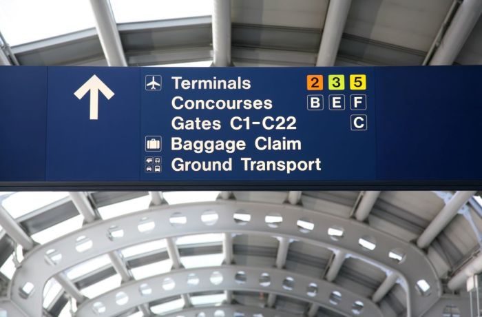 A directional sign is displayed in an airport terminal at Chicago O'Hare International Airport in Chicago, Illinois. 