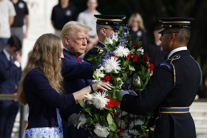 Republican presidential nominee, former U.S. President Donald Trump stands alongside Misty Fuoco, whose sister Sgt. Nicole Gee died in Abbey Gate Bombing, at a wreath laying ceremony at the Tomb of the Unknown Soldier at Arlington National Cemetery on August 26, 2024, in Arlington, Virginia. Monday marks three years since the August 26, 2021, suicide bombing at Hamid Karzai International Airport, which killed 13 American service members. 