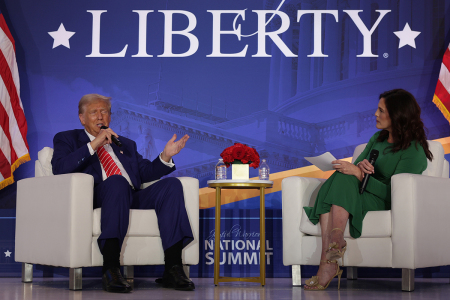 Republican presidential nominee, former U.S. President Donald Trump (L), speaks as Co-founder of Moms for Liberty Tiffany Justice (R) looks on during the 2024 Joyful Warriors National Summit on August 30, 2024, in Washington, D.C. Trump continued to campaign for the upcoming presidential election on November 5, 2024.