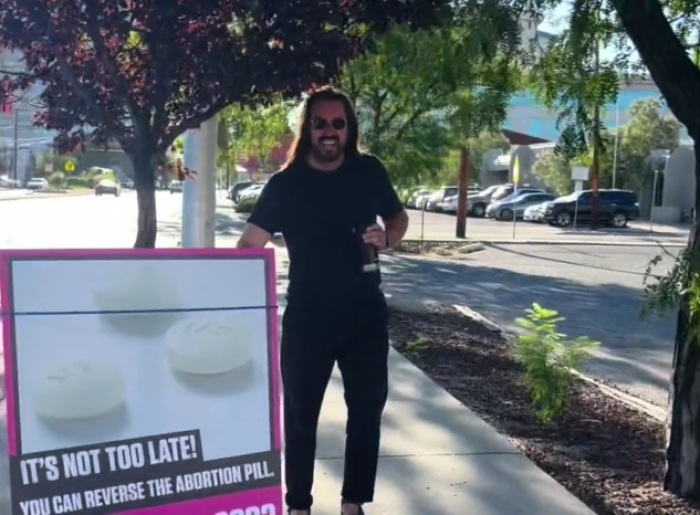 A screenshot of an individual believed to be Derek Moore stealing a sign from a pro-life demonstration held outside the Whole Woman’s Abortion Facility in Albuquerque, New Mexico, by activist Bud Shaver of Abortion Free New Mexico on Aug. 15, 2024. 