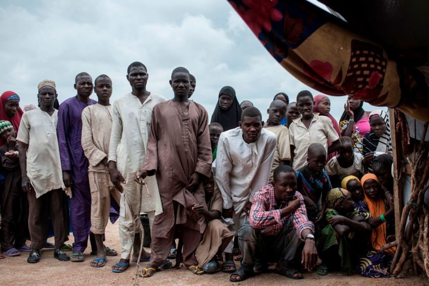 People gather outside a tent in one of the IDP (Internally Displaced People) camps in Pulka, Nigeria, on August 1, 2018. -(Photo by Stefan HEUNIS / AFP) (Photo credit should read STEFAN HEUNIS/AFP via Getty Images)