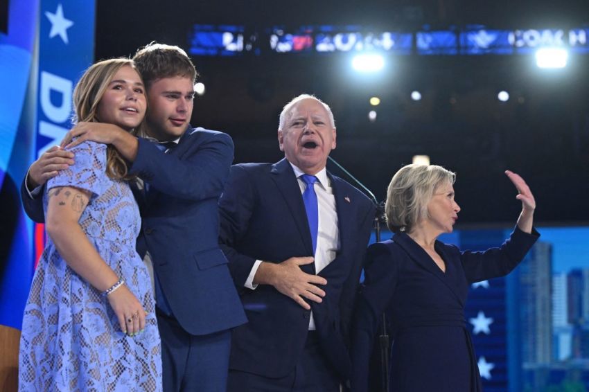 Minnesota Governor and 2024 Democratic vice presidential candidate Tim Walz (2nd R) stands with (from R) wife Gwen, and children Gus and Hope after speaking on the third day of the Democratic National Convention (DNC) at the United Center in Chicago, Illinois, on August 21, 2024.