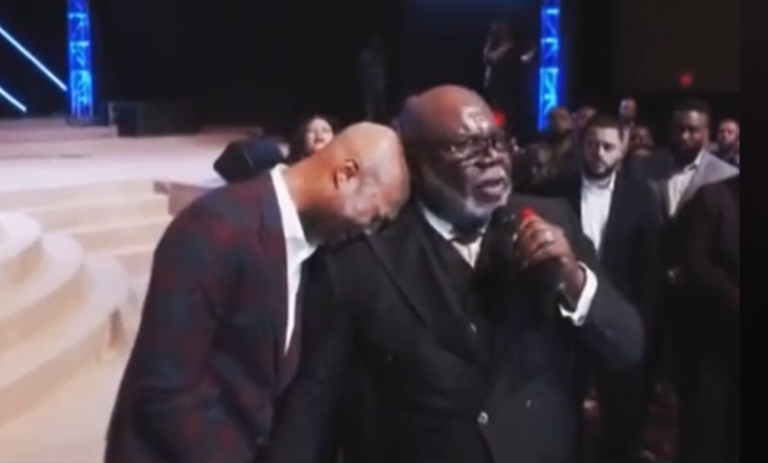 Pastor Keion Henderson cries on the shoulder of televangelist T.D. Jakes.