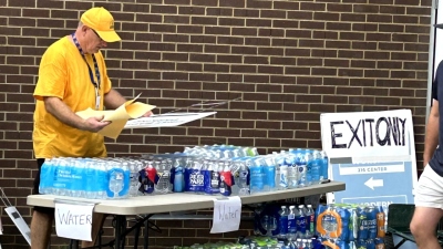 A volunteer helps distribute water to thousands who showed up for basic supplies at First Baptist Church Hendersonville in Hendersonville, North Carolina, on Sept. 30, 2024.