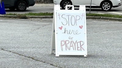 A sign outside First Baptist Hendersonville in Hendersonville, North Carolina, offers prayer to the thousands of local residents who passed through for supplies on Sept. 30, 2024.