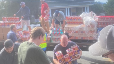 Volunteers help unload supplies to give to local residents at First Baptist Church in Hendersonville, North Carolina, on Sept. 30, 2024.