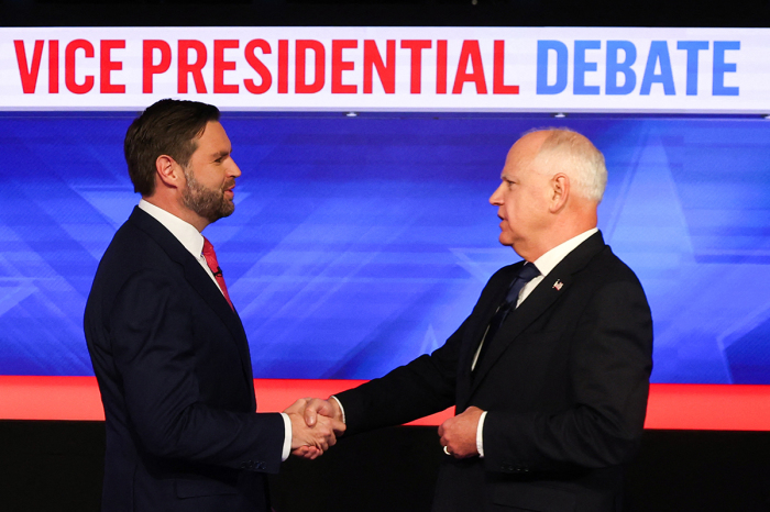 U.S. Senator and Republican vice presidential candidate J.D. Vance (L) and Minnesota Governor and Democratic vice presidential candidate Tim Walz shake hands at the start of the vice presidential debate hosted by CBS News at the CBS Broadcast Center in New York City on Oct. 1, 2024. 