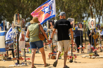 A man wearing a shirt that reads, 'we wont forger 7.10.23' holds a woman's hand while visiting the Nova festival memorial site on Oct. 04, 2024, in Re'im, Israel. Over the last few months the grounds around Re'im Park have been turned into a memorial for the victims, and hostages from the Nova music festival which was attacked by Hamas on the morning of Oct. 7th. The site has been expanded to include stories of the victims, including first responders, police, and military, with other large personalized memorials. On Oct. 7, 2023, members of Hamas mounted a series of attacks and raids on Israeli citizens in the Gaza Envelope border area of Israel. Some 251 Israelis and foreigners were kidnapped with nearly 100 still unaccounted for and 1,139 people were killed.