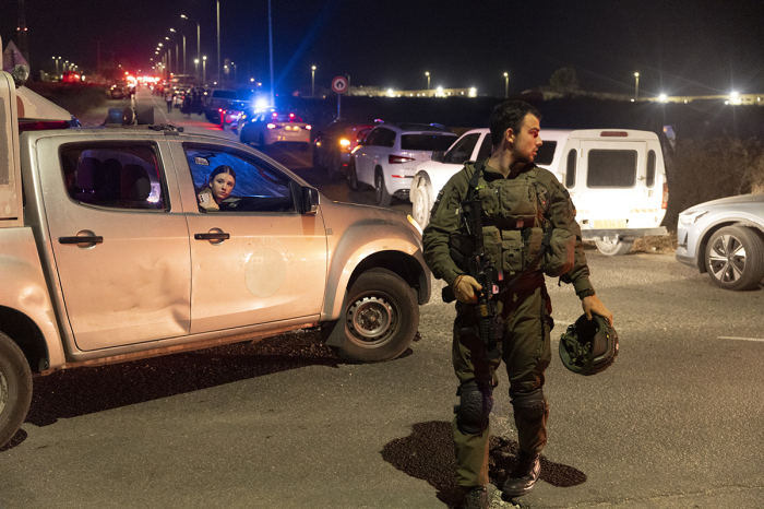 An Israeli soldier secures a road after a drone attack that caused mass casualties on Oct. 13, 2024, in Binyamina, Israel. More than 60 people were reportedly injured near Binyamina, Israel, following a drone strike launched by Hezbollah. 