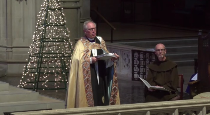 Bishop Marc Andrus (left), head of the Episcopal Diocese of California, speaks during a 2023 Christmas Eve service at Grace Cathedral of San Francisco, California. 