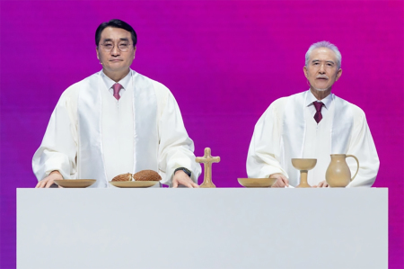 The Rev. Jaehoon Lee from South Korea and Masanori Kurasawa from Japan lead the communion service at the conclusion of the Lausanne Congress as a symbol of reconciliation in Incheon, South Korea, Sept. 28, 2024.