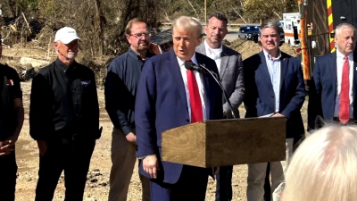 Mike Stewart stands behind former President Donald Trump during a press conference in Swannanoa, North Carolina, on Oct. 21, 2024.