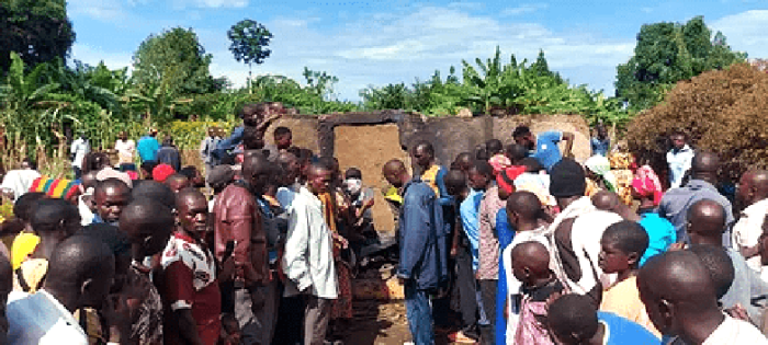 Villagers at the charred house where Pastor Mukisa and his family were burned alive in Namutumba district, Uganda, on October 13, 2024. 