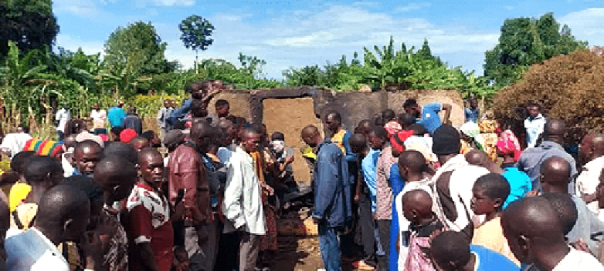 Villagers at charred home where Pastor Mukisa and family were burned to death in Namutumba District, Uganda, on Oct. 13, 2024.