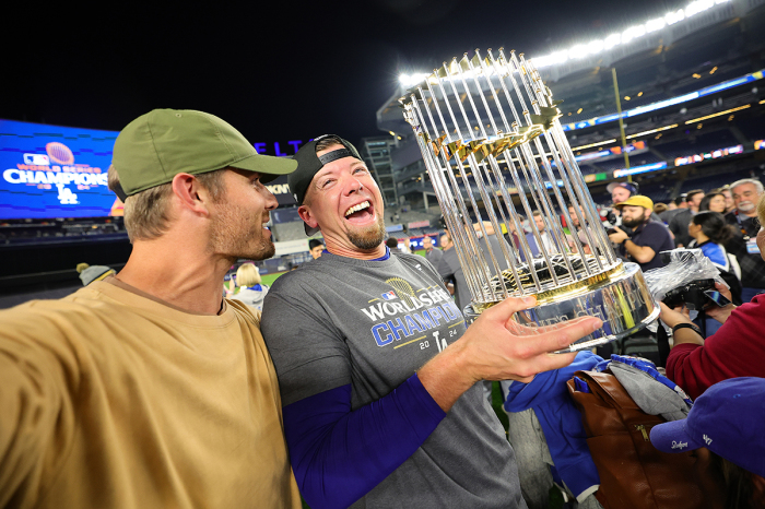 Blake Treinen #49 of the Los Angeles Dodgers celebrates with the Commissioner's Trophy after the Dodgers defeat the New York Yankees 7-6 in Game Five to win the 2024 World Series at Yankee Stadium on Oct. 30, 2024, in the Bronx borough of New York City. 