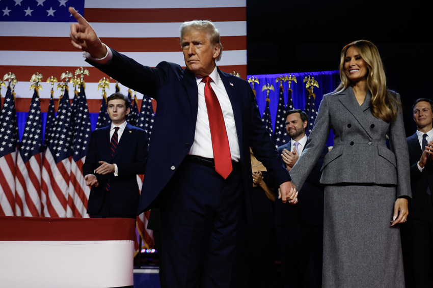 Republican presidential nominee, former U.S. President Donald Trump points to supporters with former first lady Melania Trump during an election night event at the Palm Beach Convention Center on Nov. 06, 2024, in West Palm Beach, Florida.