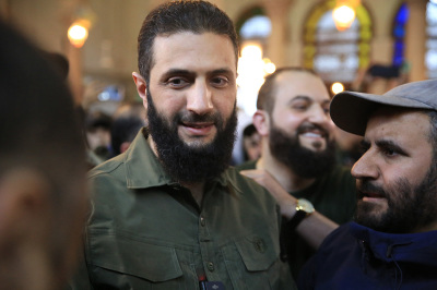 Supporters welcome the leader of Syria's Islamist Hayat Tahrir al-Sham (HTS) group that headed a lightning rebel offensive snatching Damascus from government control, Abu Mohammed al-Jolani (C), before his address at the capital's landmark Umayyad Mosque on December 8, 2024. Jolani, now using his real name Ahmed al-Sharaa, gave a speech as the crowd chanted 