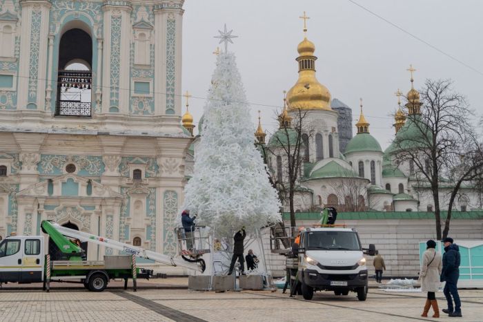 Workers set up a Christmas tree in front of the Bell Tower of Saint Sophia's Cathedral at Sophia Square ahead of Christmas and New Year celebrations in Kyiv on December 4, 2024, amid the Russian invasion of Ukraine.