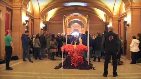 Approximately 100 citizens and lawmakers got together to pray and sing Christmas carols around the satanic display on Dec. 18, 2024.