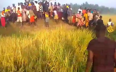 Villagers gather where the body of James Mukenye Habiibu was found on Dec. 17, 2024, in Kibuku District, Uganda.