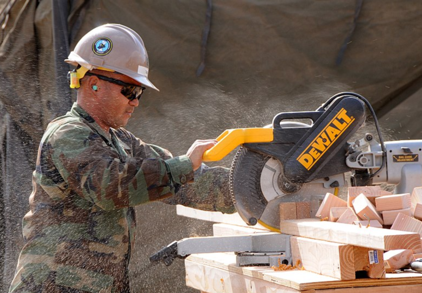 Builder 3rd Class Jermaine Takai, assigned to amphibious construction Battalion ONE (ACB-1) uses a miter saw to cut lumber for the construction of a life support area (LSA) for 800 military personnel in support of Pacific Horizon 10.