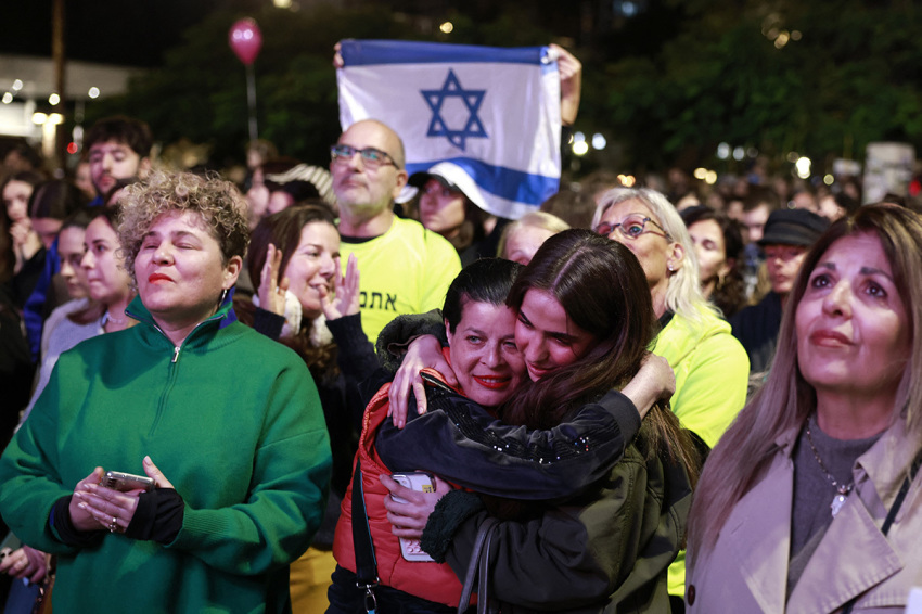 Supporters and relatives of hostages held captive in the Gaza Strip since the Oct. 7, 2023, attacks by Palestinian militants, react while watching a live television broadcast on the release of Israeli hostages, at the Hostages Square in Tel Aviv, on Jan. 19, 2025. The crowds in Tel Aviv's