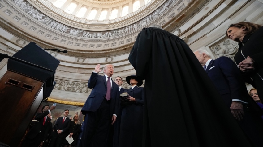 President Donald Trump takes the oath of office from Chief Justice John Roberts as Barron Trump and Melania Trump look on during inauguration ceremonies in the Rotunda of the U.S. Capitol on Jan. 20, 2025, in Washington, D.C.