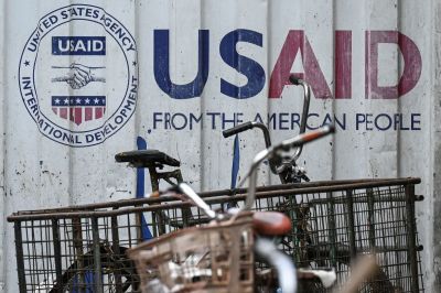 Signage for the US government's humanitarian agency USAID is seen on a cargo container beside a tricycle in Manila on February 4, 2025. The US government's giant humanitarian agency USAID announced it was placing its staff in the United States and around the world on administrative leave as it moved to recall employees from overseas postings. 