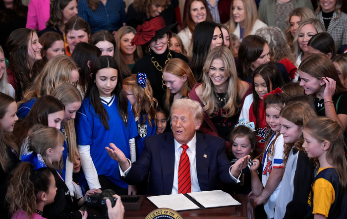 U.S. President Donald Trump joined by female athletes signs the “No Men in Women’s Sports” executive order in the East Room at the White House on Feb. 5, 2025, in Washington, D.C. The executive order, which Trump signed on National Girls and Women in Sports Day, prohibits men who identify as trans from competing in women’s sports and is the third order he has signed pertaining to trans-identified individuals.