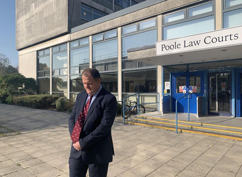Adam Smith-Connor praying outside the court in Poole where he was convicted.