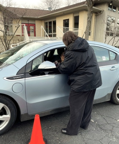 A driver receives ashes at the "Ashes to Go" event hosted by St. Hugh of Lincoln Episcopal Church of Elgin, Illinois, on Ash Wednesday 2024.