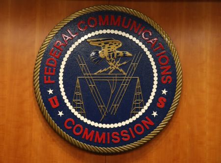 The seal of the Federal Communications Commission hangs inside the hearing room at the FCC headquarters Feb. 26, 2015, in Washington, D.C. The commission will vote on internet rules, grounded in multiple sources of the Commissions legal authority, to ensure that Americans reap the benefits of an open Internet. 