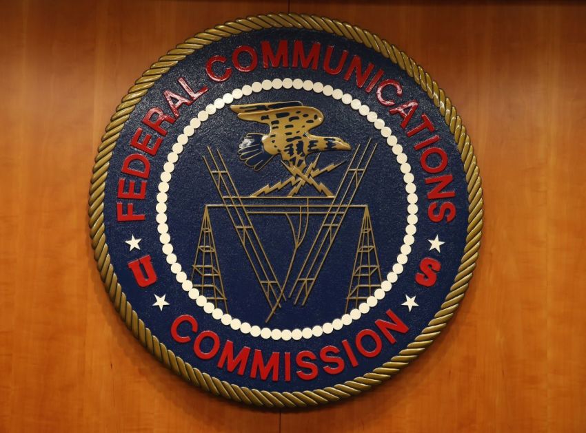 The seal of the Federal Communications Commission hangs inside the hearing room at the FCC headquarters Feb. 26, 2015, in Washington, D.C. The commission will vote on internet rules, grounded in multiple sources of the Commissions legal authority, to ensure that Americans reap the benefits of an open Internet.
