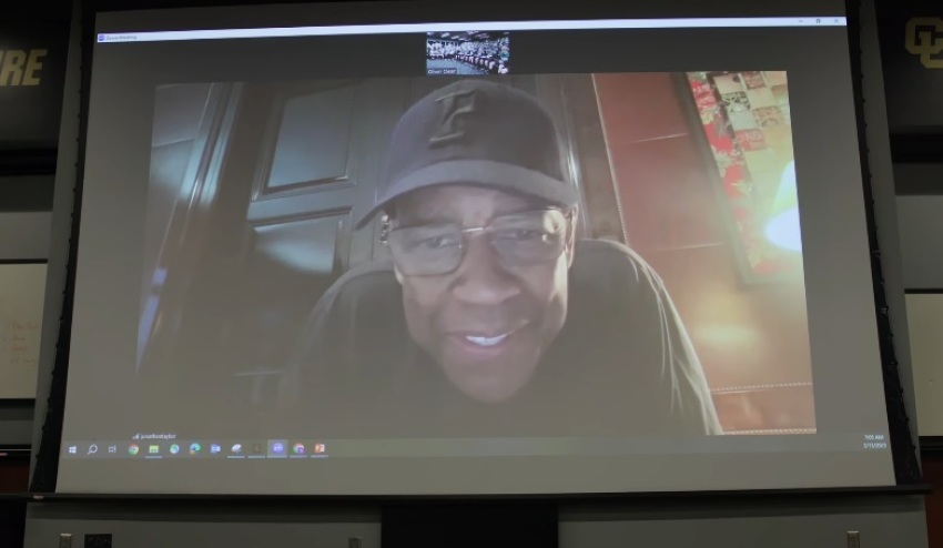 Actor Denzel Washington speaks with members of the University of Colorado football team in March 2025.