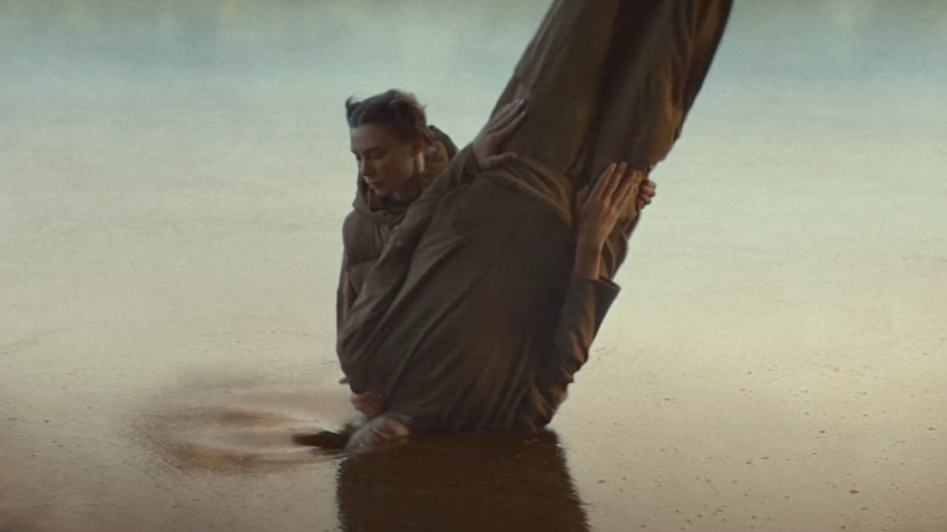 A character in KFC UKI's recent ad depicts a woman baptizing a man into a lake made of gravy before he emerges as a piece of fried chicken.