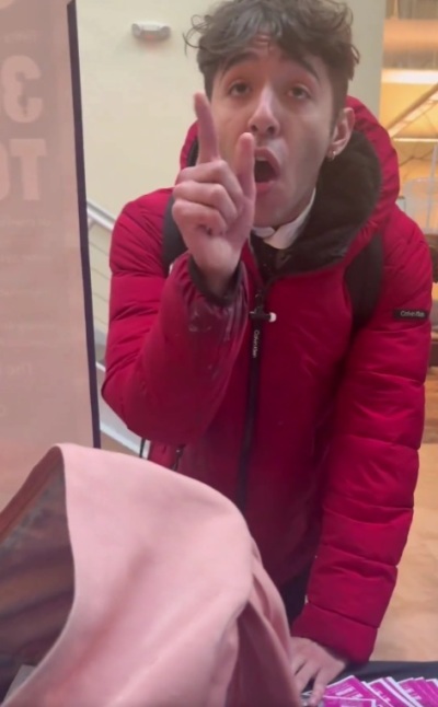 A pro-choice student confronts a Students for Life of America display at the University of North Carolina Asheville on Monday, March 24, 2025. He later throws the table display contents onto the floor. 
