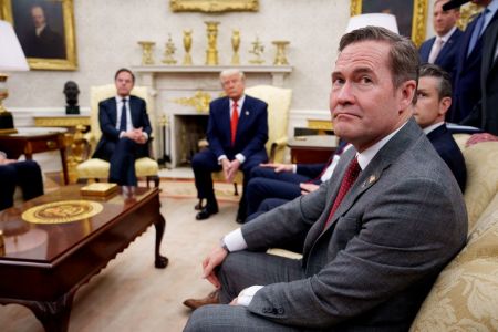 U.S. President Donald Trump, accompanied by U.S. National Security Adviser Michael Waltz (R), takes a question from a reporter during a meeting with NATO Secretary General Mark Rutte (L) in the Oval Office of the White House on March 13, 2025 in Washington, D.C. 