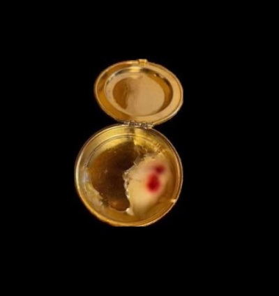 A photo of a communion host from a service at St. Anthony Catholic Church in Morris, Indiana, that some claimed had miraculously bled. However, in March 2025, further examination showed that the Eucharist piece did not have any evidence of human blood.