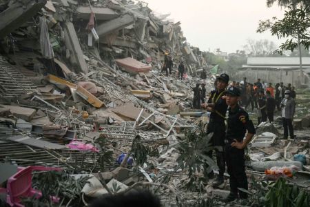 Rescuers search for survivors trapped in the collapsed Sky Villa Condominium building in Mandalay on March 29, 2025, a day after an earthquake struck central Myanmar. Rescuers pulled a woman alive from the wreckage of a collapsed apartment building in Mandalay on March 29, AFP journalists saw, 30 hours after a devastating quake hit Myanmar. (Photo by Sai Aung MAIN / AFP) (Photo by SAI AUNG MAIN/AFP via Getty Images) 