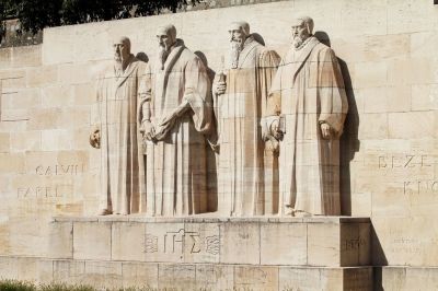 Reformation Wall in the Bastions Parc. Monument statues of the Calvinists are William Farel, John Calvin, Theodore de Beze and John Knox in Geneva, Switzerland.