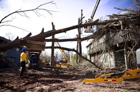 Texans on Mission crew members work on removing down trees and limbs from the property of Carla Robinette in Poplar Bluff, Missouri, in March 2025.
