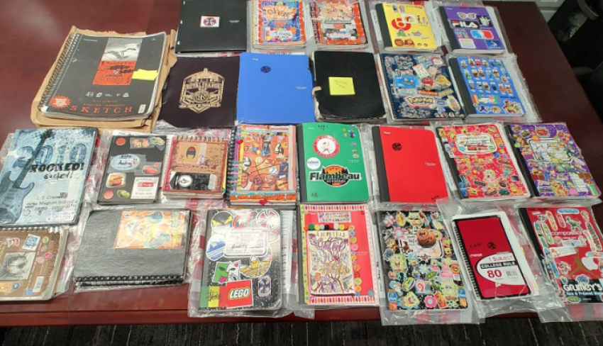 Photograph of the notebooks, composition books and sketchbooks, and folders recovered from Hale’s bedroom during a search of her residence on March 27th, 2023/
