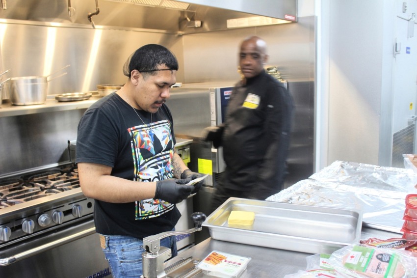 A student helps prepares lunch for his housemates at the Brooklyn Adult & Teen Challenge in Brooklyn, N.Y. on Friday April 4, 2025.