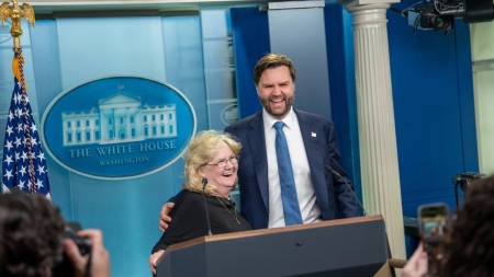 Vice President JD Vance laughs with his mother, Beverly Aikins, at the podium in the White House press briefing room in Washington, D.C.