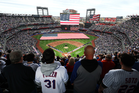 Fans stand for the National Anthem during Opening Day at Citi Field at the game between the New York Metsand the Toronto Blue Jays on April 04, 2025, in New York City. 