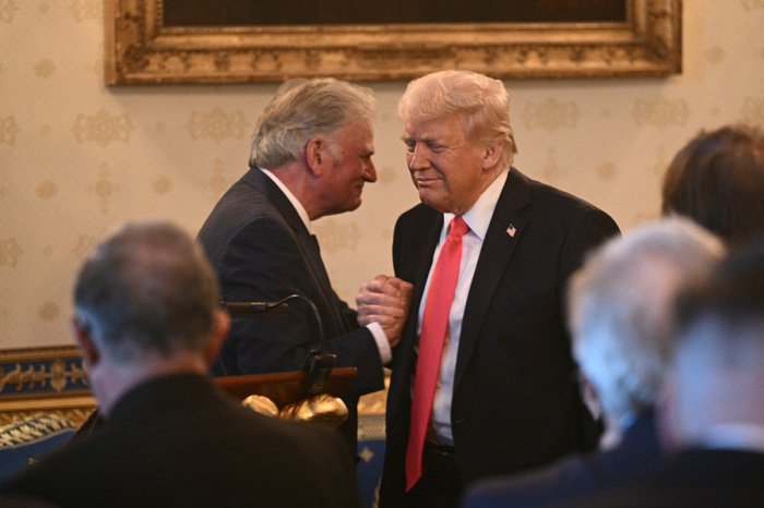 The Rev. Franklin Graham shakes hands with U.S. President Donald Trump after addressing an Easter prayer service and dinner in the Blue Room of the White House in Washington, D.C., on April 16, 2025.