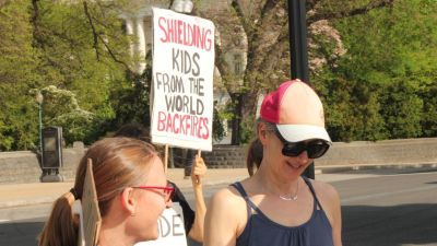 A demonstrator on the pro-LGBT side stands outside the U.S. Supreme Court on April 22, 2025, ahead of oral arguments for the case "Mahmoud v. Taylor."