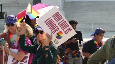 LGBT activists demonstrated outside of the U.S. Supreme Court on April 22, 2025, ahead of oral arguments for the case "Mahmoud v. Taylor."
